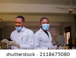 Small photo of overexcited two african doctors operating their phone
