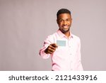 close up of a handsome african man holding his voters card