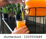 pouring the orange juice | Shutterstock . vector #1325553689