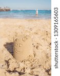 Small photo of sand castle on the beach