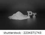 Small photo of REE - rare-earth element Praseodymium. A handful of silvery-white metallic powder and the chemical symbol Pr on a black background. Praseodymium is a rare earth metal