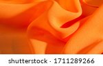 Small photo of background, pattern, texture, Orange silk fabric has a brilliant luster. It folds into soft folds when draping and is the most versatile fabric. Be creative with beautiful accents of your design.