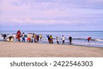 Small photo of Cartagena, Bolivar Colombia - 1 February 2024: Fishermen from Cartagena de Indias finish their daily fishing work and collect the trammel on the shore of the sea.