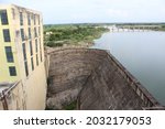 Small photo of Dam abetting the river with a power generation building nearby