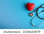  red heart and stethoscope are on blue background top view with copy space