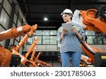Small photo of A female auditor Inspected to account for the company's robot assets that were brought to the warehouse before delivering to customers.