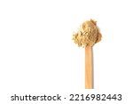 Top view of a spoon with raw maca root powder isolated on white