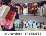 Woman holding shopping bags in...