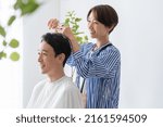 Small photo of Male and female hairdressers coming to the hairdresser