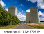 Small photo of Atomic power plant with lake behind and blue sky.