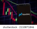 Small photo of Cali, Colombia - January 18 2021: Nasdaq logo on the smartphone screen and the chart of stock market at the blurred background.