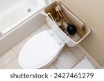 Small photo of Residential home bathroom toilet tank plumbing repair. Replacing old leaking restroom lavatory flush valve.
