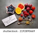 Small photo of Structural chemical formula of quercetin molecule with fresh fruit and vegetable. Quercetin is a plant pigment (flavonoid). It's found in many plants and foods such as red onions, berries, tomatoes...