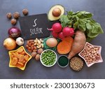 Small photo of Sulfur rich foods for hair growth. Natural food sources of sulfur with the symbol S. Healthy food to boost glutathione. Onion, garlic, dried apricot, radishes, nuts, seeds, eggs, spirulina, etc.
