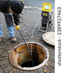 Small photo of A drain cleaning company checks a blocked drain with a camera before flushing it out