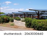 Small photo of Solar panels on the parking lot near a supermarket on a sunny day in Avignon, Provence, France. Electricity and shade for cars at the same time.