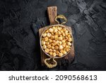 Caramel Popcorn in rustic bowl. Black background. Top view