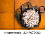 Shredded chicken meat in a plate. Orange background. Top view. Copy space.