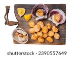 Seared Scallops fillets on a wooden board ready for eat. Isolated, white background