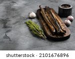 Small photo of Smoked Lamprey seafood delicacy set, on gray stone table background, with copy space for text