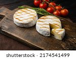 Oven Backed camembert, on old dark  wooden table background