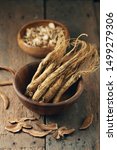 Small photo of Dry Korean ginseng Roots on wood background.Korean herbal medicine.