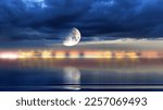 Small photo of sea at nigh ,tarry sky and big moon at sea blue cloudy dramatic sky sun light and big moon reflection on water waves nature background