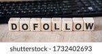 Small photo of Dofollow links - concept text on wooden cubes and in the background black keyboard