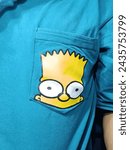 Small photo of Jhargram,India - March 06,2024:trendy young boy's T-shirt adorned with the iconic Simpsons logo, adding a touch of fun and pop culture flair to his casual style.