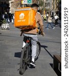 Small photo of VALENCIA, SPAIN - FEBRUARY 13, 2024: A Just Eat courier on a bike in downtown Valencia. Just Eat is an online food order and delivery brand of Netherlands based Just Eat Takeaway.com.