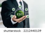 Small photo of business hand of human holding green earth ESG icon for environmental, social and governance for sustainable organizational development. ​account the environment, society and corporate governance