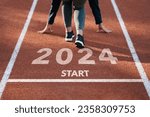 Small photo of happy new year 2024 symbolizes the start of the new year. Rear view of a man preparing to run on the athletics track engraved with the year 2024. The goal of Success.Getting ready for the new year