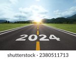 Small photo of The word Happy New Year 2024 or Start 2024 on the road or highway with a sunrise or sunset background. for forward to the goal. Concept of planning, challenge, new year resolution.