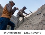 Small photo of Guides recut a section of trail that eroded into the Karavshin River of the Pamir Alay mountain range in southwest Kyrgyzstan near the border of Tajikistan on September 2, 2018.