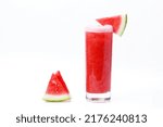a glass of watermelon juice and small pieces of sweet and fresh on a white background