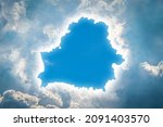 Small photo of In the sky, clouds have dispersed in the form of a map of Belarus. Concept of Divine Omen, Prophecy, Hope, Heavenly Sign for Country and Nation. Soft focus.