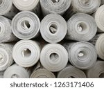 Small photo of rolls of white banking commercial bills piled one onto another
