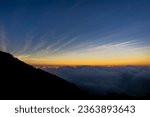 View of the sea of ​​clouds at sunset and several mountains on the Dieng plateau, Central Java, Indonesia