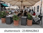 Small photo of ROME APRIL 22 2022 A VIEW OF SAN.LORENZO IN LUCINA SQUARE CROWDED WITH PEOPLE WITH TABLES OUTSIDE