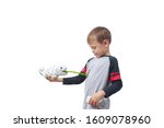Small photo of Infatuated child boy playing plastic toy lizard robot with a remote control, isolated on white background. The nano-toy Chameleon spat out a tongue in the child. Modern nano technology of toys.