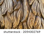 closeup front view of bronze sculpture strands of hair texture