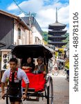 Small photo of KYOTO, JAPAN - OCTOBER 14, 2015 - Japanese pulled rickshaws called jinrikisha, carrying tourists through the old streets of Kyoto
