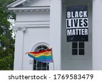 A Black Lives Matter banner and LGBT flag displayed outside a church in Lexington, Massachusetts