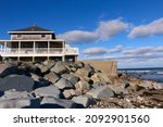 Small photo of View of a seaside house built against a seawall in Scituate, Massachusetts