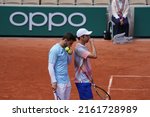 Small photo of Paris, France - 29 May 2022: Marcel Granollers and Horacio Zeballos talking after a point in their doubles match against O'Mara and Withrow on day 8 of the Roland Garros tennis tournament