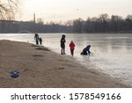 Small photo of Moscow, Russia, November 24, 2019: the first ice on the city pond at the beginning of winter. Children and adults walk on thin ice at the edge of the shore