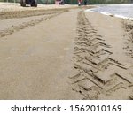 the motorized wheel tracks on the beach sand