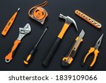 Set of tools on black background. Construction, DIY concept. Equipment,  workplace. Flat lay composition. Screwdriver, tape measure, wrench, knife, hammer and pliers. 