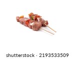 Small photo of Raw meat and vegetable skewer, isolated on white background. In gastronomy, brochette (from the French brochette, meaning "skewer", "skewered") refers to meals served skewered on a skewer (brochette).