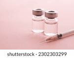 
Syringe and vial on pink background. Image of cosmetic medicine and cosmetic surgery.